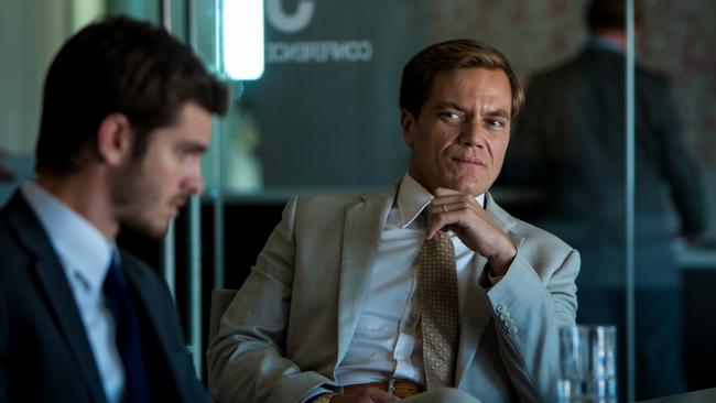 In this image released by Broad Green Pictures, Andrew Garfield portrays Dennis Nash, left, and Michael Shannon portrays Rick Carver in a scene from "99 Homes." (Hooman Bahrani/Broad Green Pictures via AP)