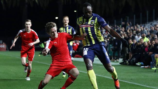 Olympic sprinter Usain Bolt, playing for A-League football club Central Coast Mariners, fights for the ball.