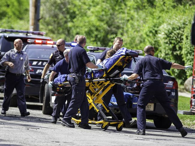 Stabbed: A 12-year-old girl is taken to an ambulance in Waukesha. AP Photo/Abe Van Dyke