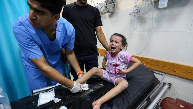 An injured Palestinian girl arrives at Nasser Medical Hospital following Israeli air strikes. Picture: Getty Images