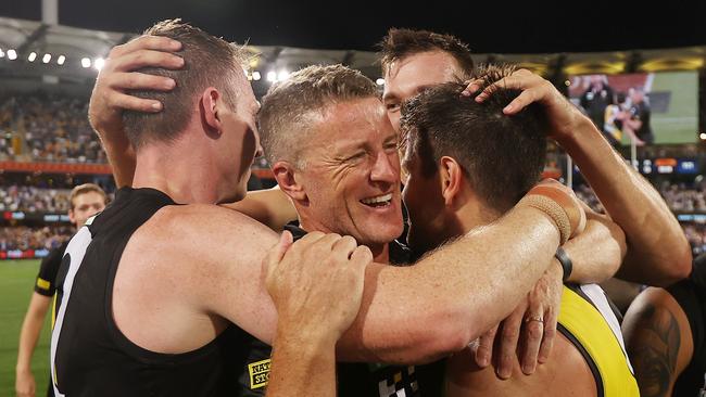 Damien Hardwick is mobbed by Trent Cotchin, Dylan Grimes and Noah Balta post-match.