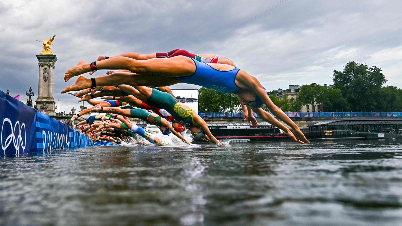 Ladies first: athletes went ahead and competed in the swimming race in the Seine at the women's individual triathlon on July 31. Picture: Martin Bureau/POOL/AFP