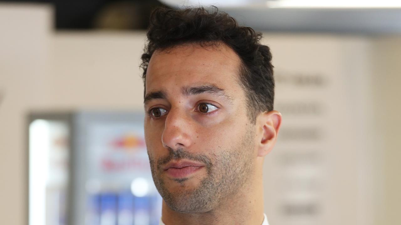 BUDAPEST, HUNGARY - JULY 20: Daniel Ricciardo of Australia and Scuderia AlphaTauri talks with the Scuderia AlphaTauri team in the garage during previews ahead of the F1 Grand Prix of Hungary at Hungaroring on July 20, 2023 in Budapest, Hungary. (Photo by Peter Fox/Getty Images)