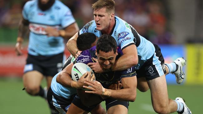 MELBOURNE, AUSTRALIA - APRIL 16: Reimis Smith of the Storm is challenged by Teig Wilton of the Sharks during the round six NRL match between the Melbourne Storm and the Cronulla Sharks at AAMI Park, on April 16, 2022, in Melbourne, Australia. (Photo by Robert Cianflone/Getty Images)