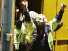 Tasmanian miners Todd Russell and Brant Webb (obscured) wave as they emerge from the mine lift having been rescued after being trapped underground at Beaconsfield gold mine for 14 days, May 9, 2006 in Beaconsfield, Australia. The two miners were involved in a mining accident 14 days ago after an earthquake caused a rock fall, but were found alive but trapped by fallen rocks almost one kilometre below the surface. Another miner, Larry Knight was killed in the accident. (Photo by Ian Waldie/Getty Images)