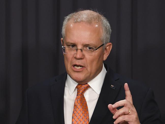 (L-R) Australian Federal Treasurer Josh Frydenberg, Australian Prime Minister Scott Morrison and Australian Finance Minister Mathias Cormann speak to the media during a press conference after the passing of the Government's income tax package plan at Parliament House in Canberra, Thursday, 4 July, 2019. (AAP Image/Lukas Coch)