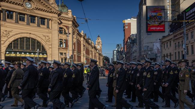 ADF personnel march past Flinders Street Station. Picture: Getty Images