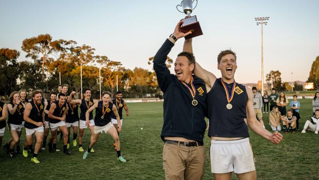 Scotch Old Collegians coach Kym Cobb and captain Lachlan Giles lift the trophy after winning last season’s division three flag. Picture: AAP/Morgan Sette