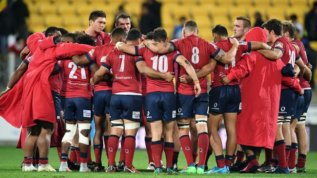 Reds players huddle together following the loss to the Hurricanes.