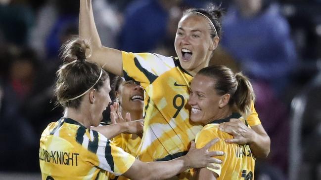 Matildas players celebrate Caitlin Foord’s (centre) stunning strike against the US on Friday. Picture: AP 