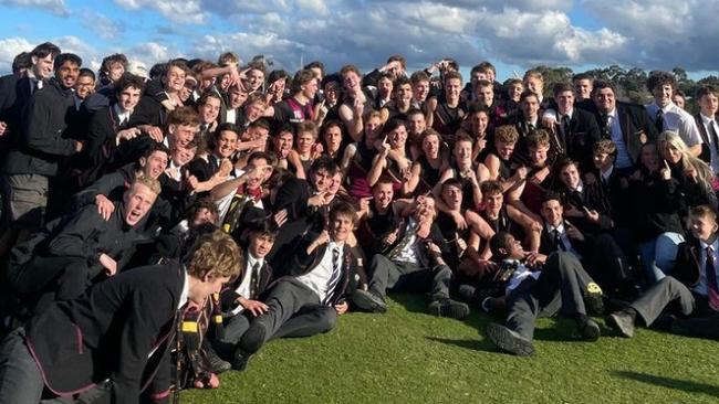 Haileybury players and students celebrate their victory against Caulfield.