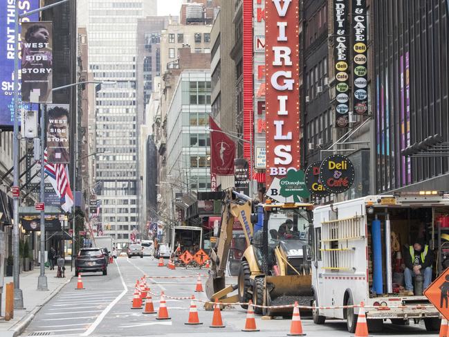 Construction workers are seen on an empty street in New York's Times Square. Picture: AP