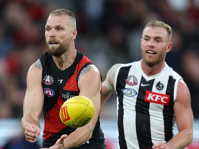 MELBOURNE, APRIL 25, 2024: 2024 AFL Football Round 7 - Anzac Day Match - Essendon V Collingwood at the MCG. Jake Stringer under pressure from Tom Michell. Picture: Mark Stewart