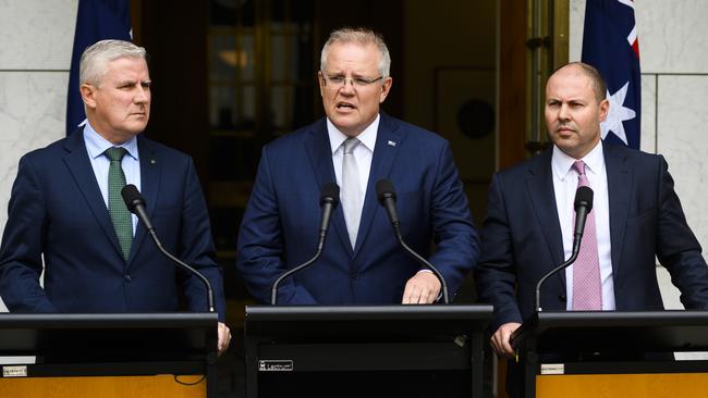 Prime Minister Scott Morrison speaks alongside Deputy Prime Minister Michael McCormack (left) and Treasurer Josh Frydenberg at Parliament House on Monday. Picture: Rohan Thomson/Getty Images