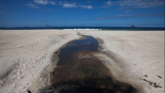 Raw sewage flows out onto Sao Conrado Beach, a rich area. Picture: Eliseu Cavalcante for Rio Gringa