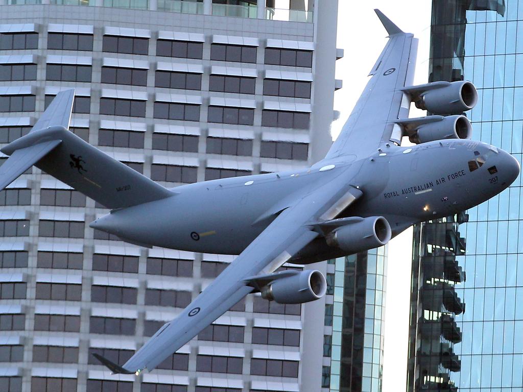 The RAAF’s Boeing C-17 Globemaster flies close to Brisbane's CBD buildings. Picture: AAP/Richard Gosling