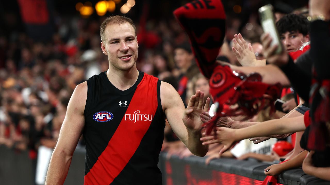 MELBOURNE, AUSTRALIA - MARCH 30: Ben McKay of the Bombers high fives fans after winning the round three AFL match between Essendon Bombers and St Kilda Saints at Marvel Stadium, on March 30, 2024, in Melbourne, Australia. (Photo by Quinn Rooney/Getty Images)