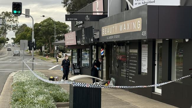 Forensics inspecting at a Merrylands barber shop on Merrylands Rd after a suspected arson attack. Picture: Aymon Bertah