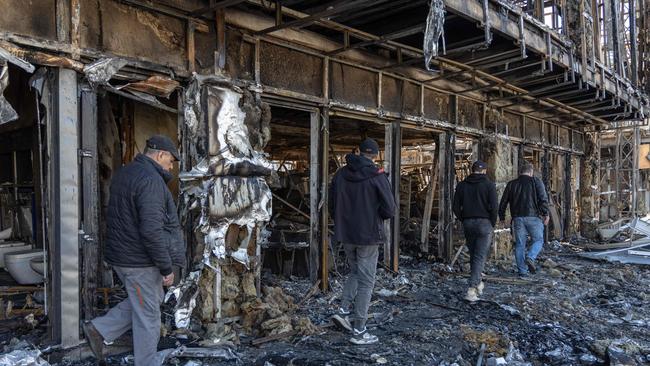 Employees walk on the rubble of a shopping mall destroyed following a drone attack in Odesa on March 21, 2025, amid the Russian invasion of Ukraine. Picture: AFP