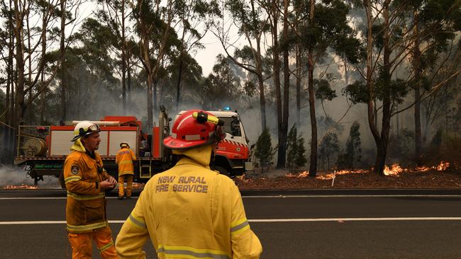 Rural Fire Service volunteers and Fire and Rescue NSW officers battling a blaze at Ulladulla in January 2020. Picture: Dean Lewins/AAP