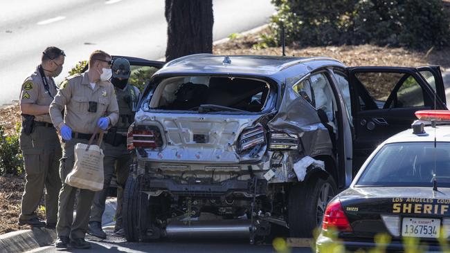 Los Angeles County Sheriff deputies gather evidence from the car. Picture: Getty