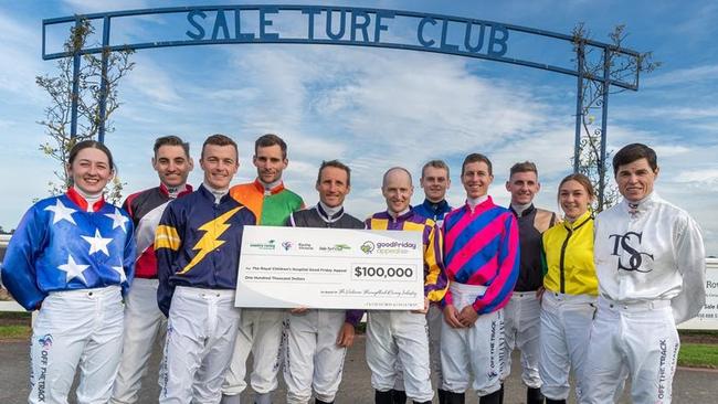 Jockeys at Sale show off the $100,000 Good Friday Appeal cheque from the Victorian racing industry. Picture: Racing Photos