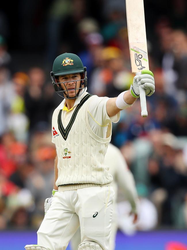 Tim Paine raises the bat after his half-century.