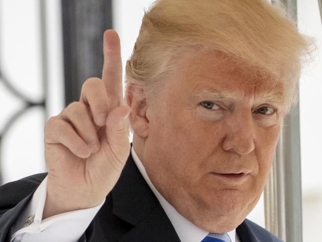 In this May 4, 2018 photo, President Donald Trump signals to the press that he will come over to talk, as he leaves the White House for Dallas to address the National Rifle Association in Washington.  Trump is striking a combative tone against the Russia probe. Heâ€™s talking about â€œFighting Backâ€ and telling Democrats on the special counselâ€™s team, â€œwait â€˜till the Courts get to see your unrevealed Conflicts of Interest!â€ Trump tweeted Monday about Robert Muellerâ€™s investigation into possible collusion between the Trump campaign and Russia.  (AP Photo/J. Scott Applewhite)