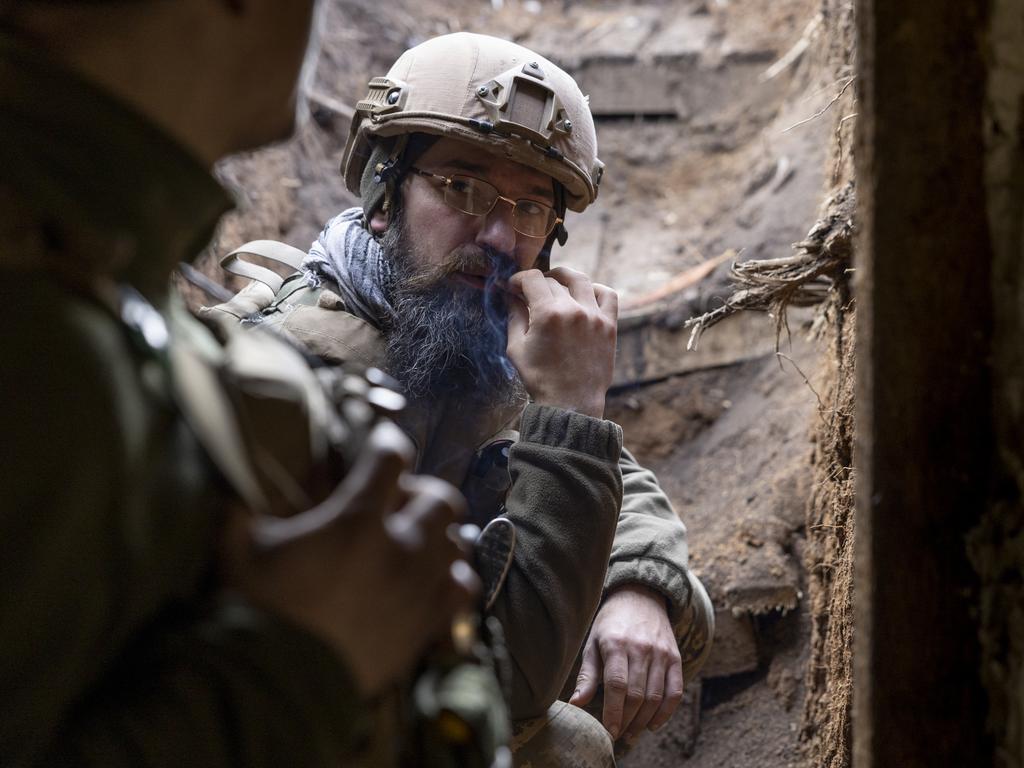 Soldiers from a Ukrainian assault brigade smoke in a bunker while waiting for orders to fire a British made L118 105mm Howitzers on Russian trenches. Picture: Getty Images