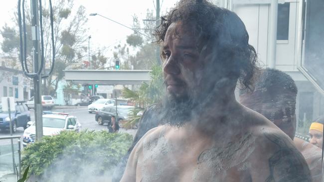 Damon Miri Anderson performing a smoking ceremony during Naidoc Week celebrations at the Toowoomba Courthouse.