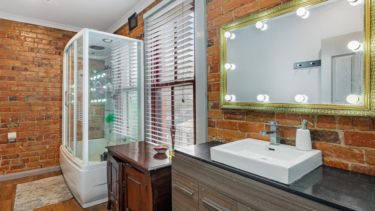 A bathroom with a glam mirror.