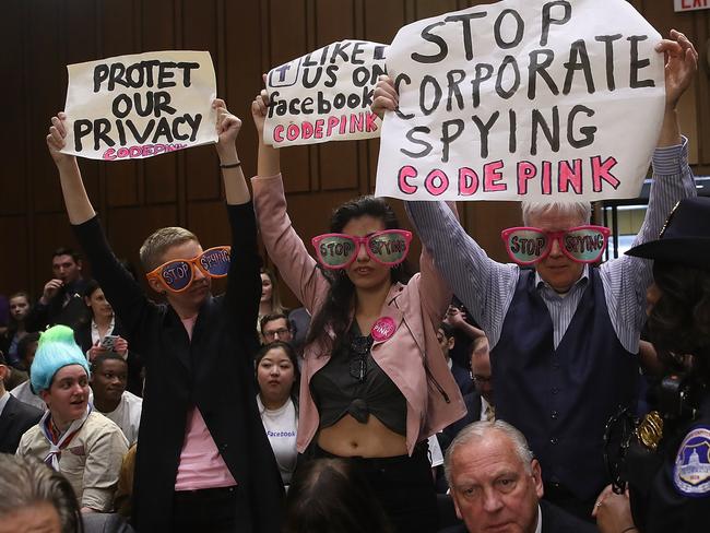 Protesters attend the hearing where Facebook co-founder, Chairman and CEO Mark Zuckerberg testified before a combined Senate Judicary and Commerce committee.  Picture:  Getty