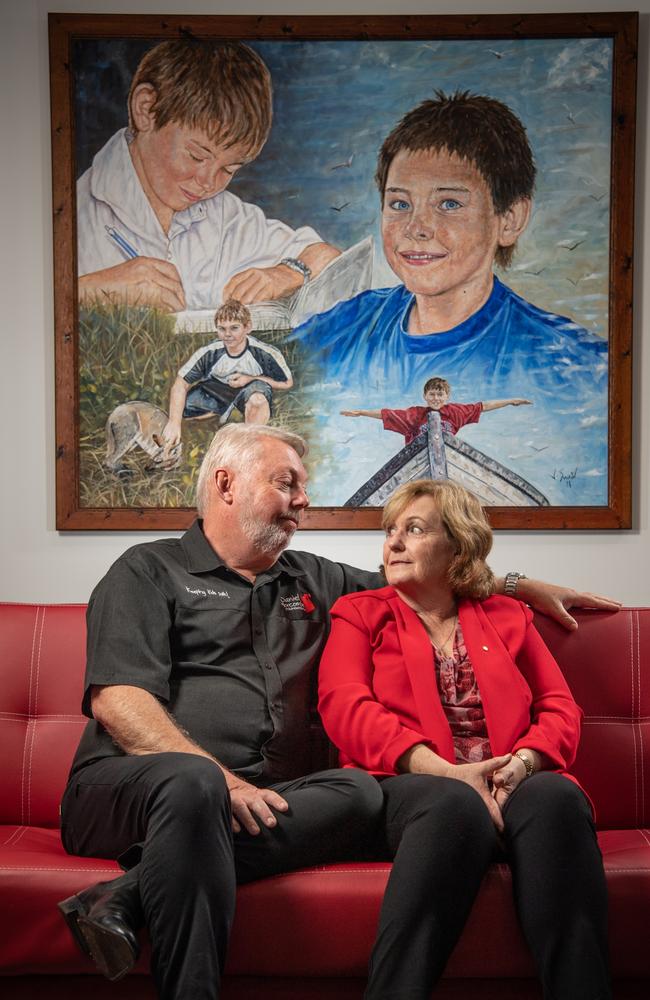 Bruce and Denise Morcombe at Daniel House in Palmwoods with a painting of Daniel behind them.