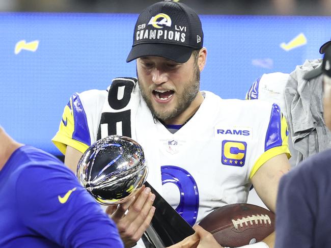 INGLEWOOD, CALIFORNIA - FEBRUARY 13: Matthew Stafford #9 of the Los Angeles Rams reacts as he holds the Vince Lombardi Trophy after the win against the Cincinnati Bengals following the NFL Super Bowl 56 football game at SoFi Stadium on February 13, 2022 in Inglewood, California. The Rams won 23-20. (Photo by Michael Owens/Getty Images)