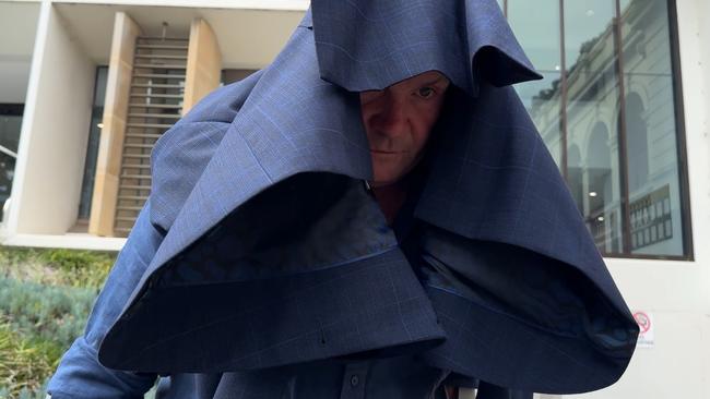 Mahon Civil Contractors director Noel Mahon leaving Wollongong Local Court underneath his solicitor’s jacket in January. Picture: Dylan Arvela