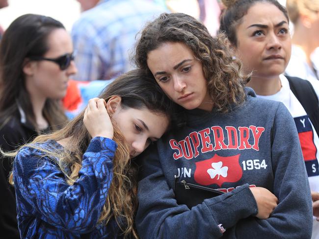 Mourners show their respects on the corner of Burke and Elizabeth st. Picture: Alex Coppel.