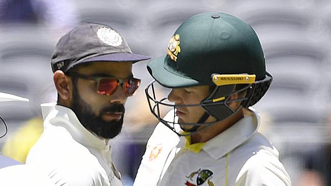 Indian captain Virat Kohli (left) and Australian captain Australian captain Tim Paine touch after Paine ran a single during play on day four of the second Test match between Australia and India at Perth Stadium in Perth, Monday,  December 17,  2018.  (AAP Image/Dave Hunt) NO ARCHIVING, EDITORIAL USE ONLY, IMAGES TO BE USED FOR NEWS REPORTING PURPOSES ONLY, NO COMMERCIAL USE WHATSOEVER, NO USE IN BOOKS WITHOUT PRIOR WRITTEN CONSENT FROM AAP