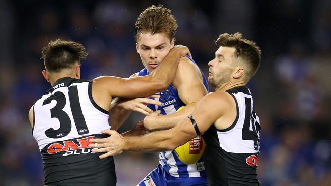 North Melbourne's Cameron Zurhaar gets tackled by Port Adelaide's Aidyn Johnson and Sam Gray on Saturday. Picture: Michael Klein