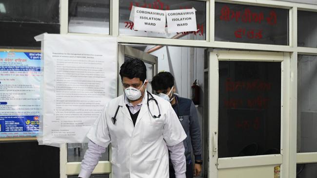 Doctors are seen in front of an isolation ward for COVID-19.