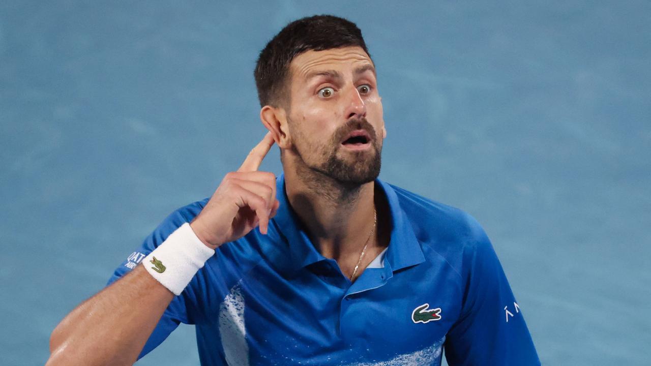 Djokovic gestures to the crowd after winning the third set. (Photo by DAVID GRAY / AFP)