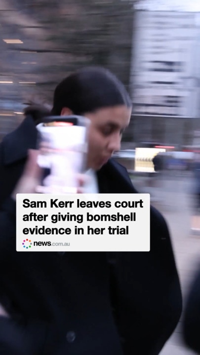 Sam Kerr speeds into a car as she rushes out of court