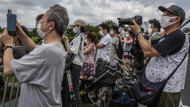 Spectators gather to watch the men's BMX freestyle seeding event from a nearby bridge in Tokyo. Picture: Yuichi Yamazaki, Getty Images