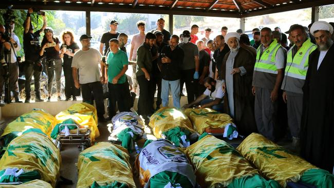 Mourners surround the bodies of people killed in Israeli airstrikes on el-Karak in Lebanon's eastern Bekaa Valley.