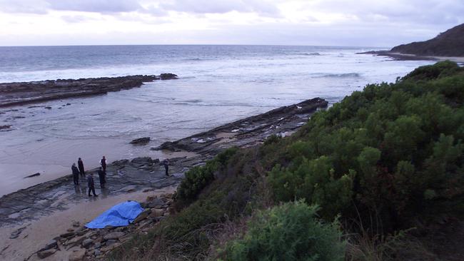 Police investigate the discovery of a body on the lonely beach where the drop occurred. Picture: Phillip Stubbs