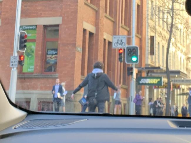 A young man is seen brandishing a knife on Clarence Street in Sydney. The image was taken by a driver in their Mercedes Benz at the scene. Picture: Twitter / @Ayusha77