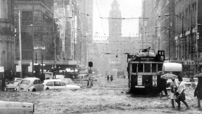 A flash flood turned Elizabeth Street, Melbourne, into a raging torrent on February 17, 1972. Picture: Herald Sun