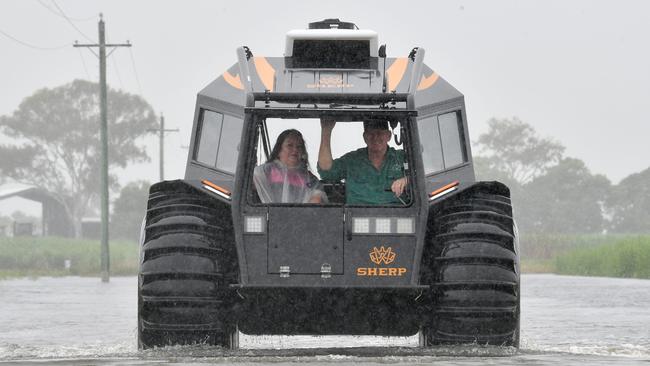 Groper Creek Caravan Park manager Jeanette Garvey rides with Peter Collings in his amphibious Sherp. Picture: Evan Morgan