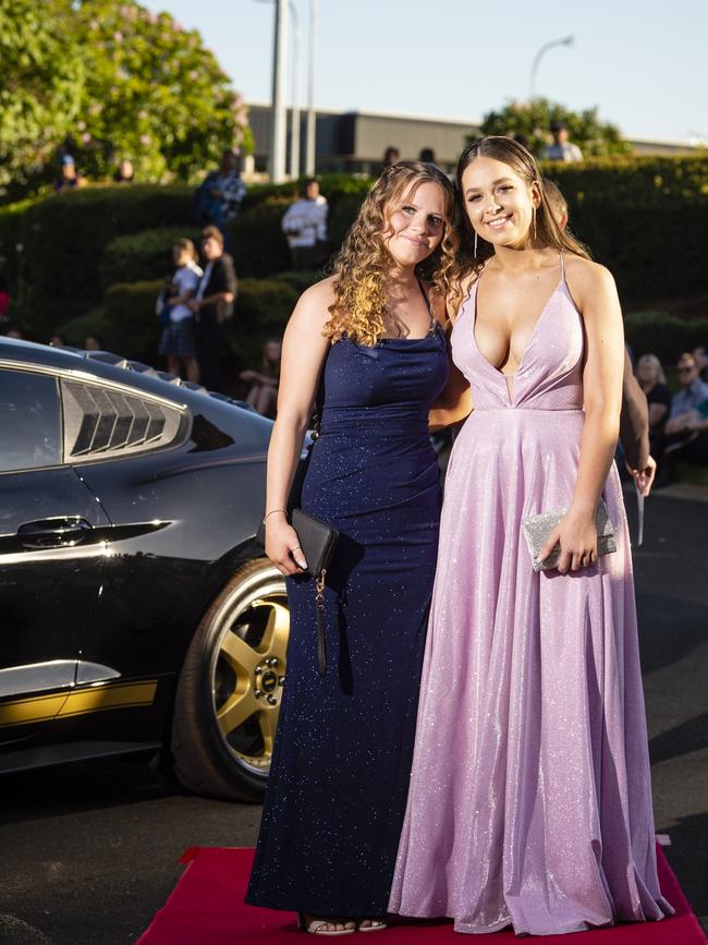 Imogen Scotney (left) and Shelby Caldwell arrive at Harristown State High School formal at Highfields Cultural Centre, Friday, November 18, 2022. Picture: Kevin Farmer