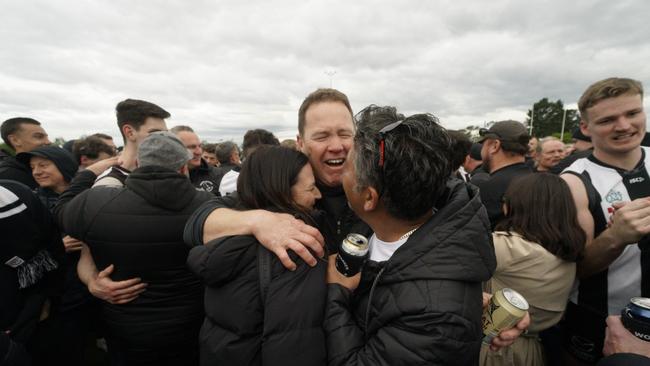 An emotional Narre Warren coach Steve Kidd is embraced after the win. Picture: Valeriu Campan