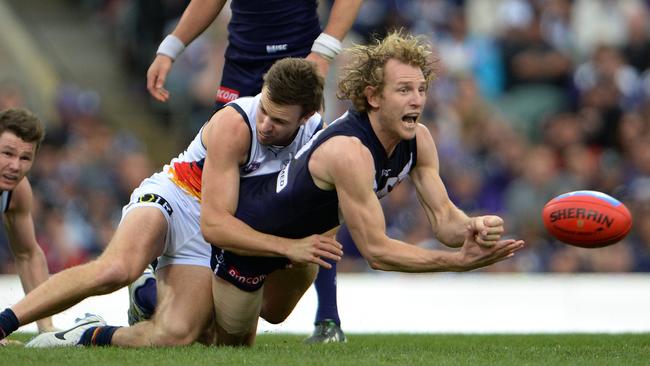 Docker David Mundy dishes off a handball under pressure. Picture: Daniel Wilkins